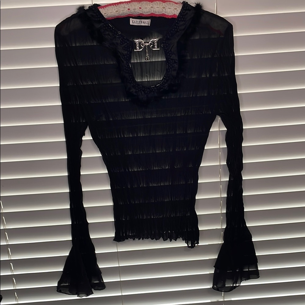 Black sheet ruffled top with intricate collar and buckle